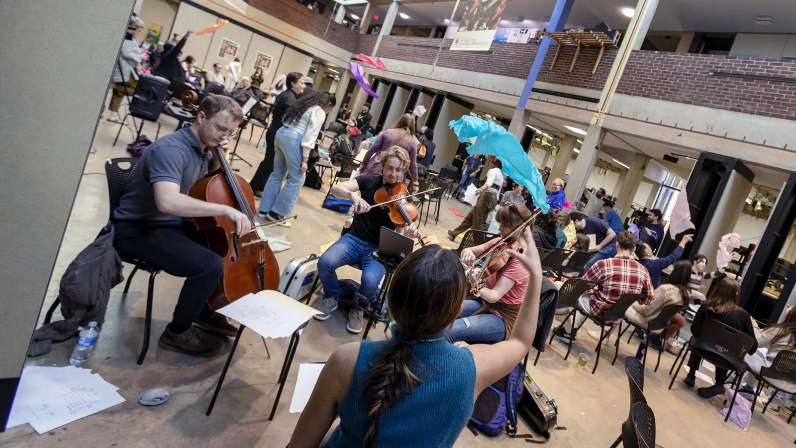 People playing instruments and throwing colorful paper in the air.